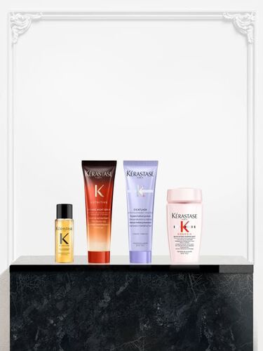 Vier Kerastase-Miniaturprodukte ausgestellt: das Elixir Ultime Ol, das Nutritive Magic Night Serum, die Cicaflash-Pflege aus der Blond Absolu-Linie und ein Produkt aus der Kerastase Genesis-Reihe.