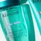Close-up of two Kerastase hair care products: a blue shampoo bottle labeled "Bain Exextensioniste" and a conditioner tube labeled "Fondant Extentioniste," both from the Resistance line.