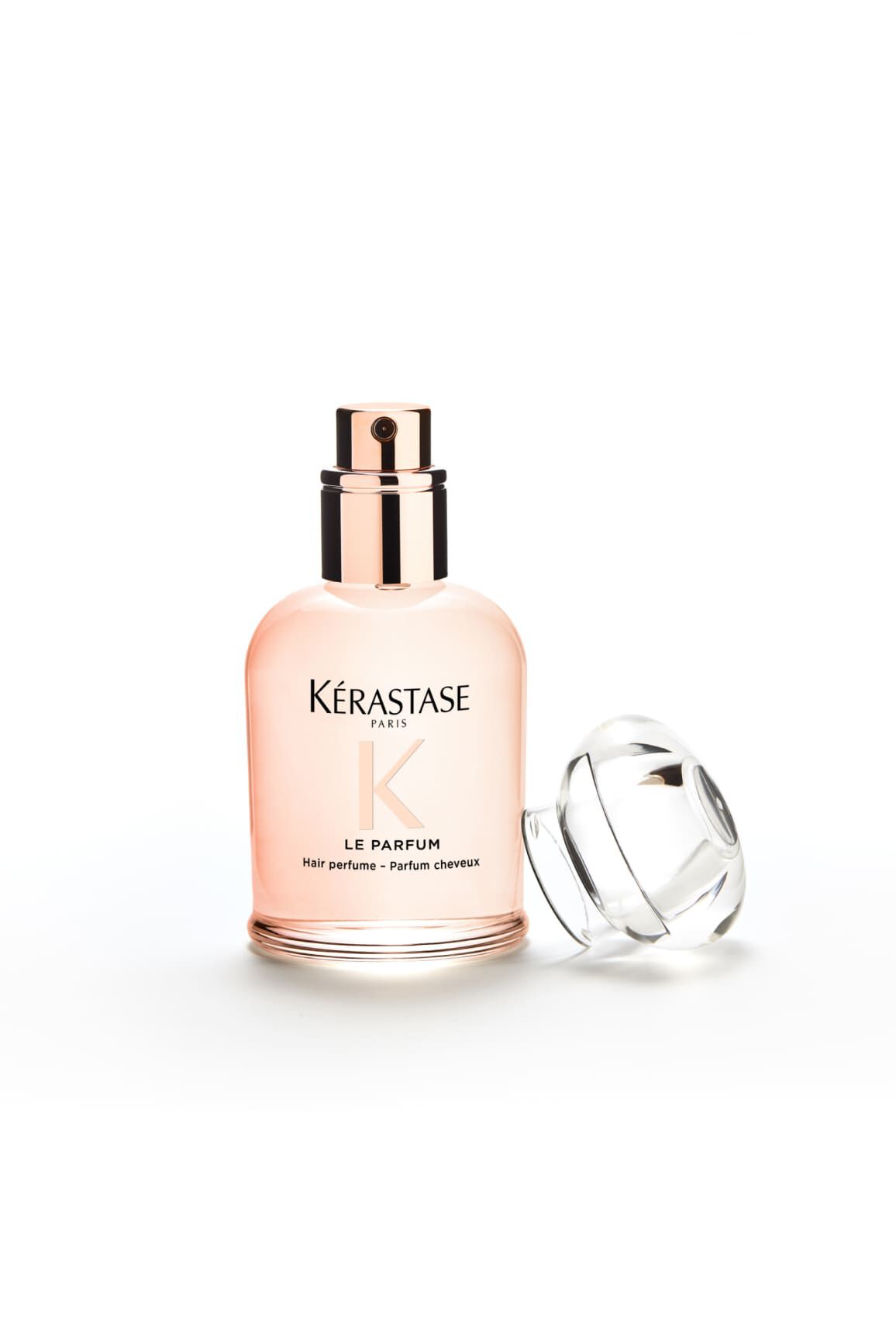 Flakon des Parfums Gloss Absolu, sein Verschluss liegt daneben