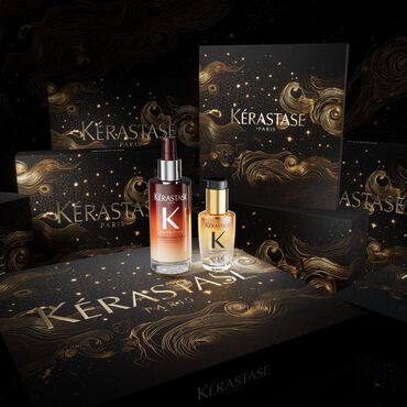 Aesthetic display of Kerastase hair care products surrounded by elegant, dark packaging featuring swirling gold designs.