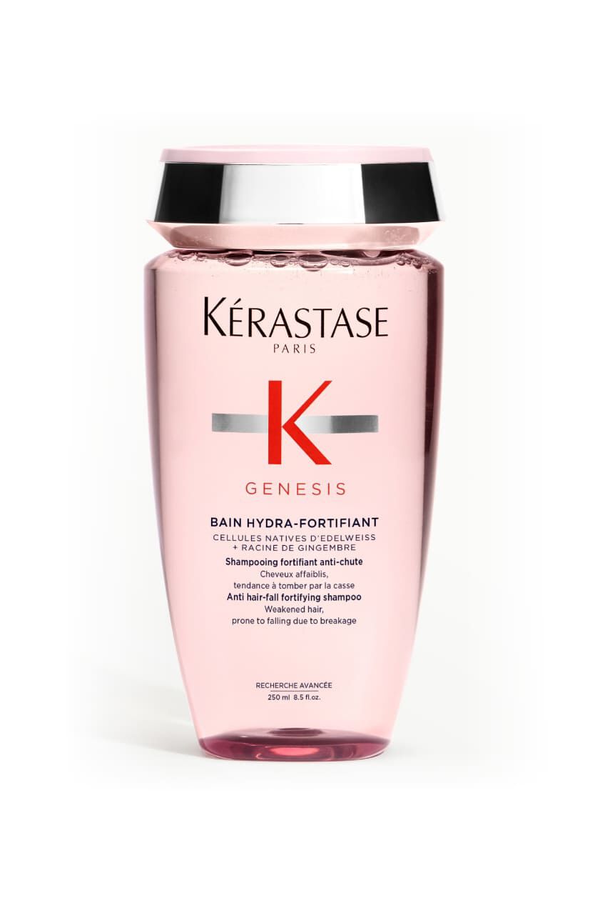 Transparentrosa Flasche des Kerastase Genesis Bain Hydra-Fortifiant Shampoos fur geschwachtes Haar, geneigt.