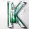 A green bottle of hair serum is displayed at the center, surrounded by flowing green gel tubes on a white marble background, with a stylized letter "K" formed by the arrangement.