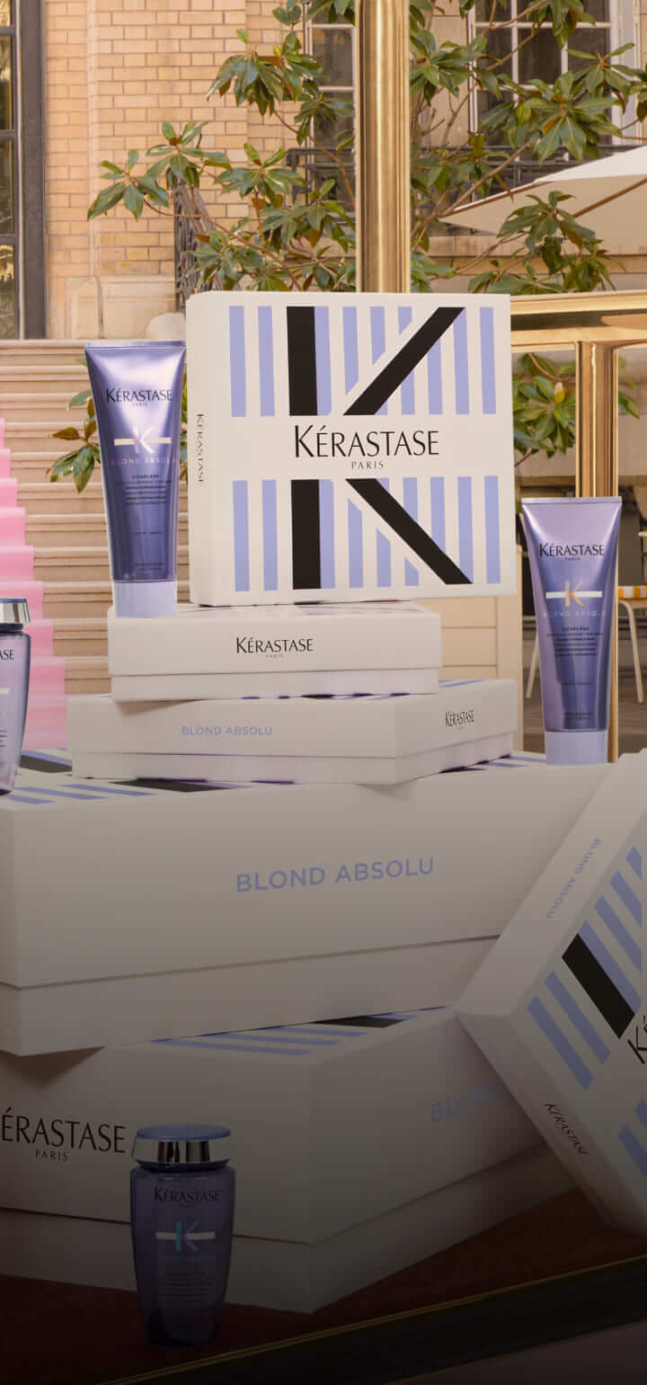 Haarpflegeprodukte von Kérastase in eleganter Umgebung, Fokus auf die Blond Absolu Linie.