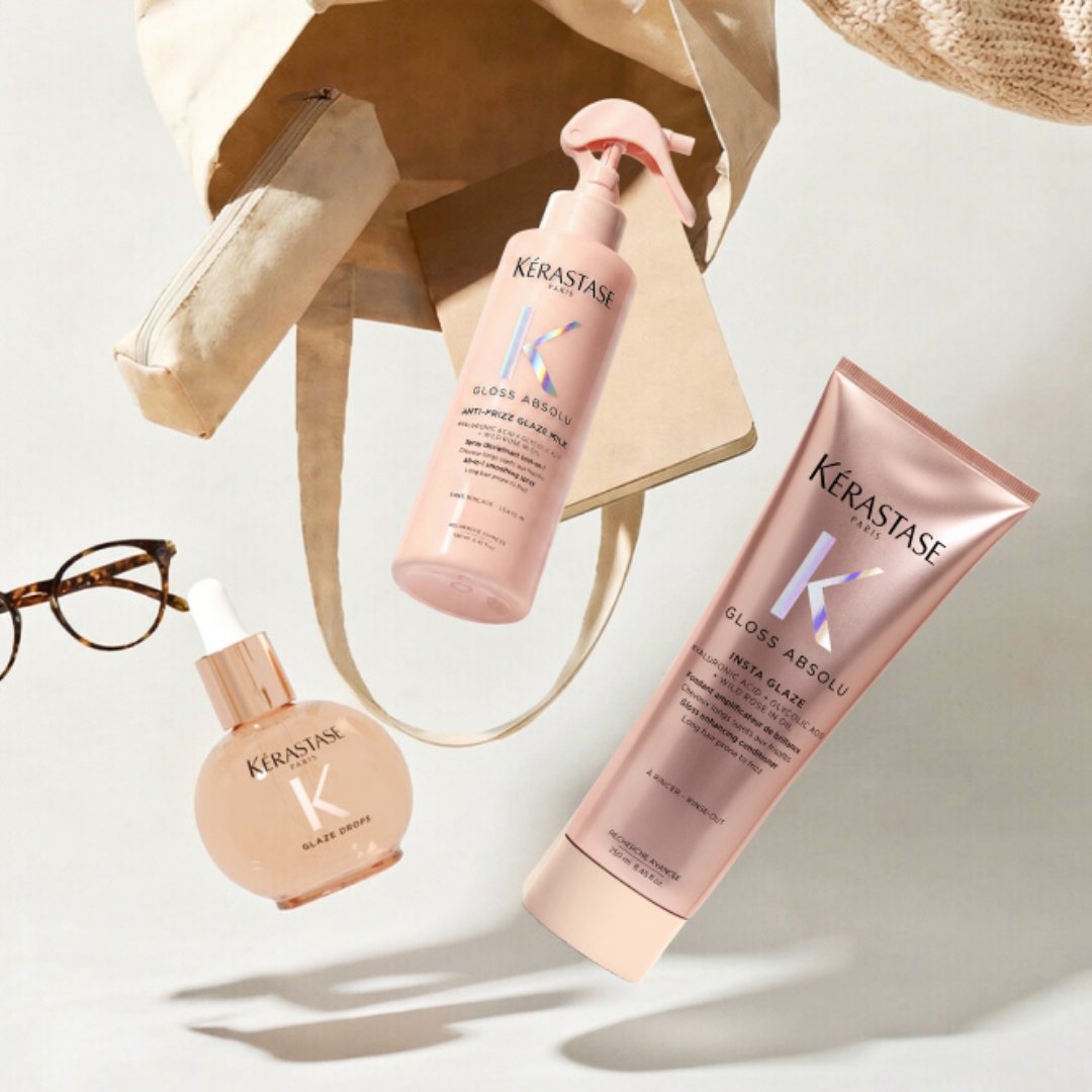 Die Produkte der Pflegelinie Gloss Absolu ragen aus einer Strohtasche und hängen in der Luft.